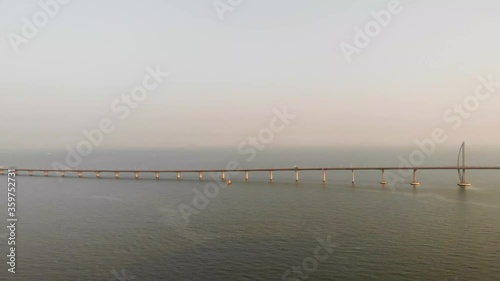 Panning aerial shot of famous Hong Kong - Zhuhai - Macau Bridge during golden hour photo