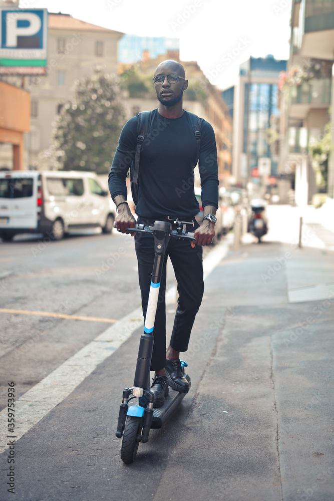 boy travels with scooter in the city boy travels with scooter in the city
