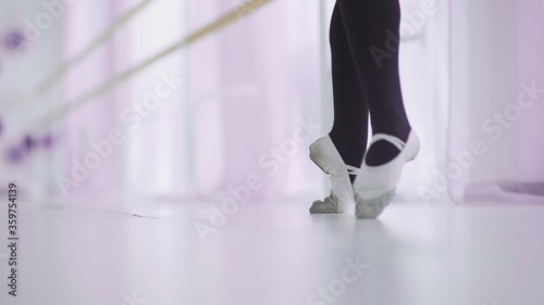 Dance of the ballerina. Female ballet dancer dancing in pointe shoes in studio.