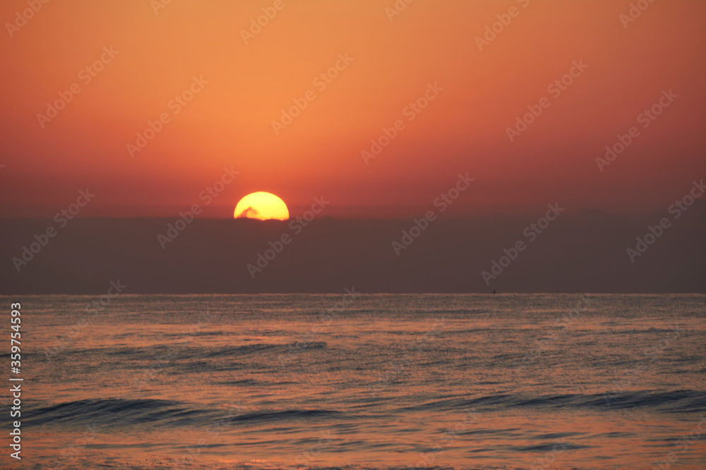 Sunrise in the ocean, the sun appears