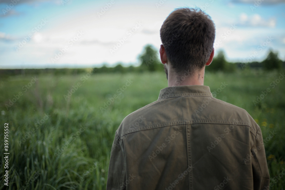 Man standing in wheat field. Horizontally framed shot. Man standing in wheat field. Horizontally framed shot.