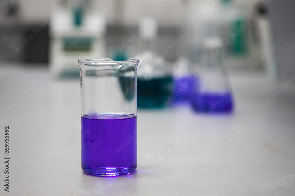 Purple chemical solutions in a science laboratory. Analytical chemistry Purple chemical solutions in a science laboratory. Analytical chemistry