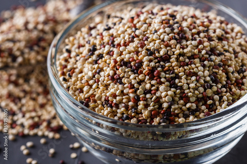 mix of quinoa grains on a dark stone background