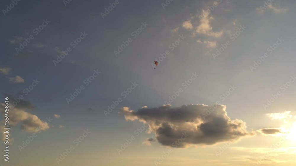 Paramotor flying in the sunset Paramotor flying in the sunset