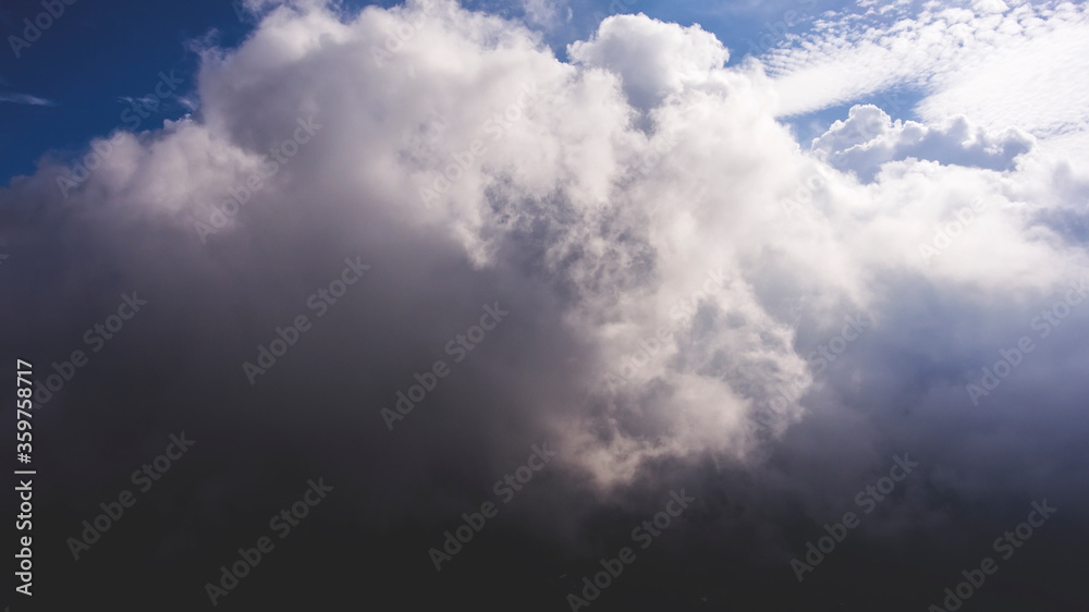 Obraz premium Aerial photo from flying drone of a many little fluffy clouds with sun rays. Amazingly beautiful sky background with copy space. Wonderful skies landscape