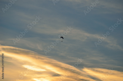 Paraglider on bright and vivid dawn sky in the arctic circle