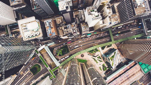 Top view aerial photo from flying drone of a developed Hong Kong city with modern skyscrapers with contemporary design. China town with business and financial centers and road with cars