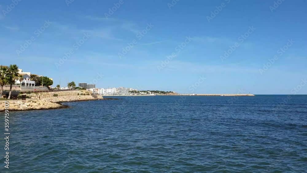 View of Typical Mediterranean Town L'Ampolla, Spain with the Calm Mediterranean Sea at Autum on a sunny Day View of Typical Mediterranean Town L'Ampolla, Spain with the Calm Mediterranean Sea at Autum on a sunny Day