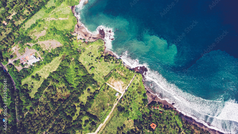 Aerial drone photo top view of the Indian Ocean waves meet or occur with a large white sand beach. Rich beautiful color water as a background for travel blog or web site. Amazing nature landscape