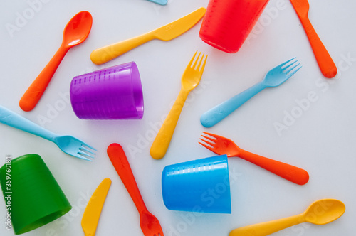 vibrant multicolored forks, kives and spoons (white background)