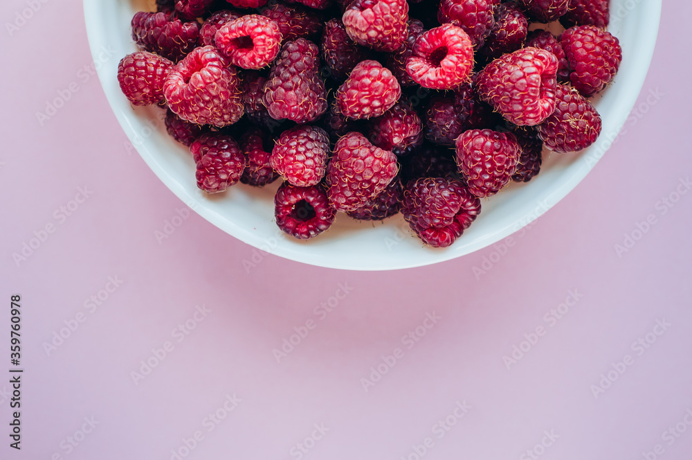 a beautiful light blue bowl of fruit with raspberries, blueberries and blackberries on yellow background, top view, studio shot a beautiful light blue bowl of fruit with raspberries, blueberries and blackberries on yellow background, top view, studio shot