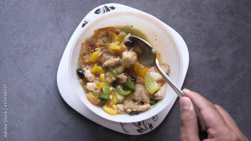 Man hand eating chicken vegetable soup Man hand eating chicken vegetable soup