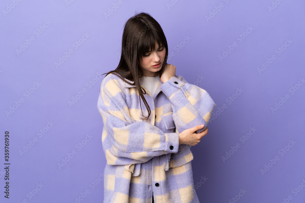 Young Ukrainian woman isolated on purple background with pain in elbow Young Ukrainian woman isolated on purple background with pain in elbow