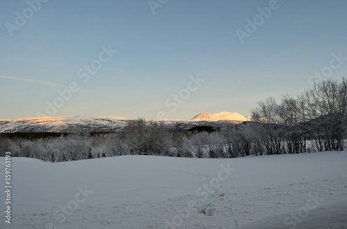 mountain, forest and field covered with snow and frost ice after cold winter day