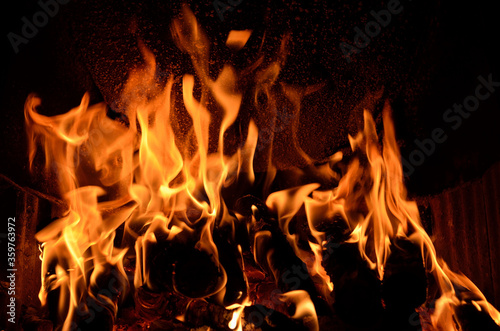 Hot vivid burning birch logs in fireplace
