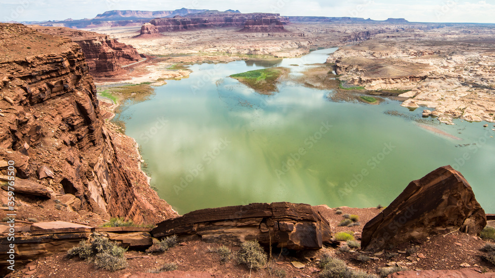 Green coloured Colorado River flowing in a red sandstone canyon in Arizona
