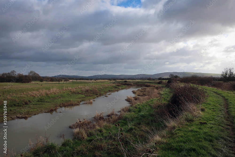 Countryside landscape of River Ader and meadow near Shoreham-by-Sea, England
