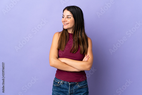 Young caucasian woman isolated on purple background happy and smiling © luismolinero