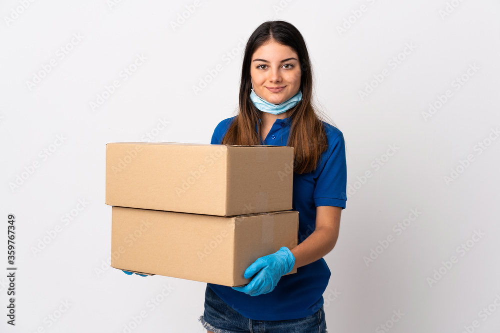 Young delivery woman protecting from the coronavirus with a mask isolated on white background smiling a lot Young delivery woman protecting from the coronavirus with a mask isolated on white background smiling a lot