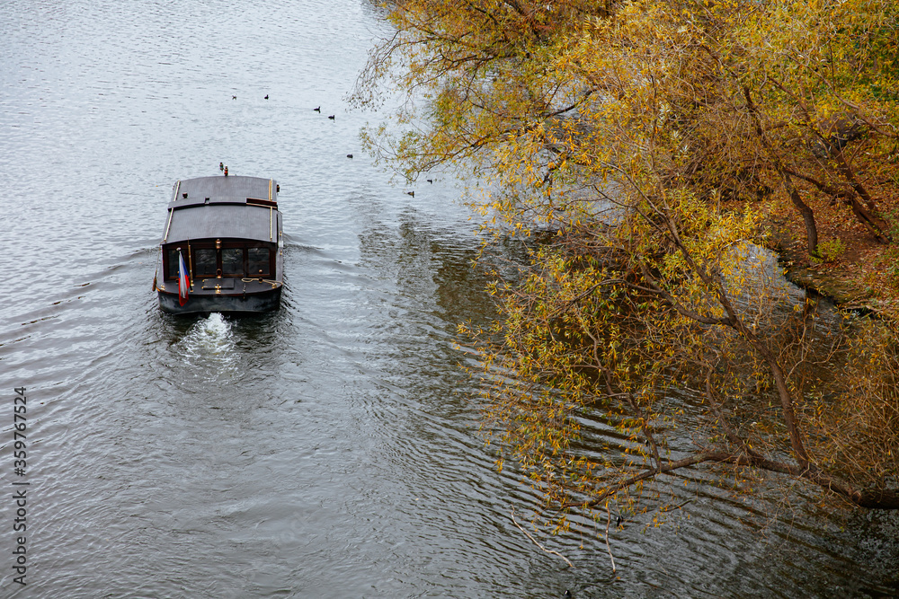 Dark wooden boat going with the stream of river Dark wooden boat going with the stream of river