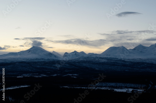 Deep scenic snow covered mountain range and forest in the arctic circle in January 2014