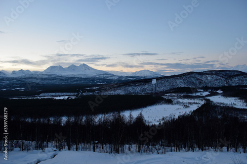 Snow covered mountains and forest in january in Norway