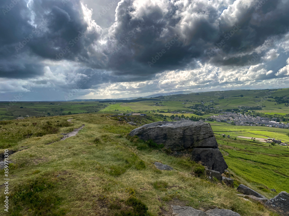 Landscape view.  from the Cowling Pinnacle, with heavy thunder clouds, and oncoming rain in, Cowling, Keighley, UK