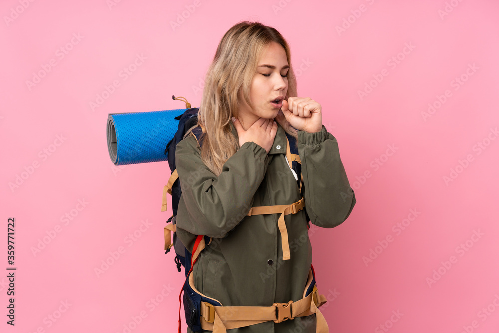 Teenager Russian mountaineer girl with a big backpack isolated on pink background is suffering with cough and feeling bad Teenager Russian mountaineer girl with a big backpack isolated on pink background is suffering with cough and feeling bad