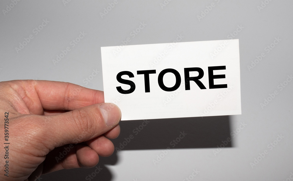 Message on the card STORE, in hands of businessman. Message on the card STORE, in hands of businessman.