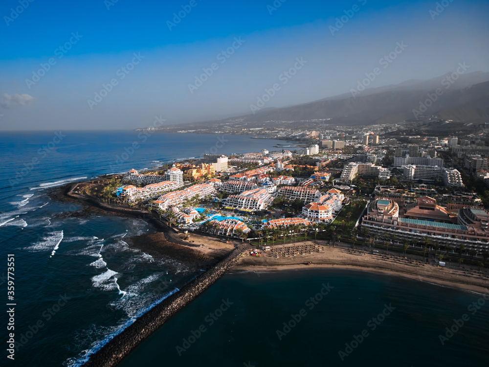 Aerial view of peninsula coastline. Big hotel resort in Playa de las Americas, Tenerife, Canary Islands, Spain. 