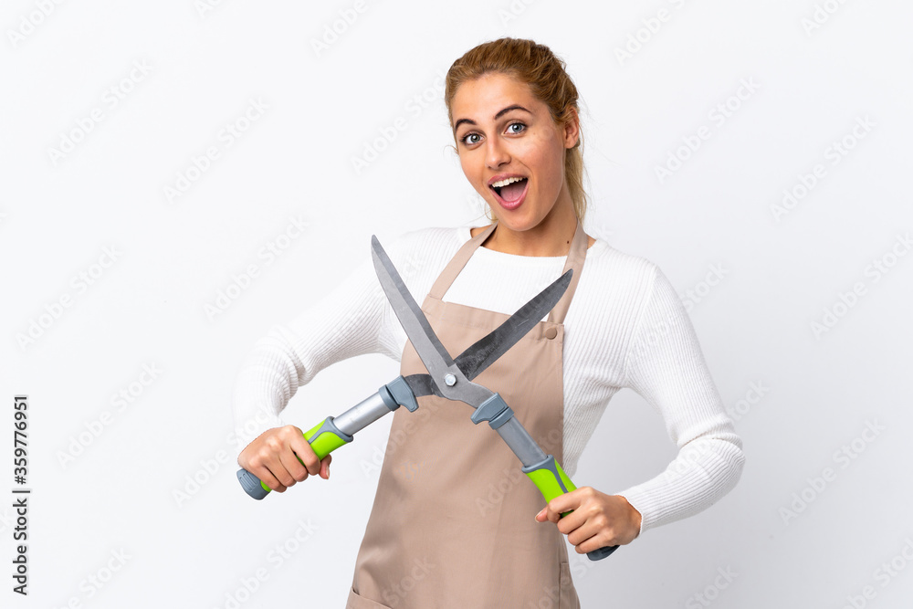Young blonde gardener woman over isolated white background Young blonde gardener woman over isolated white background