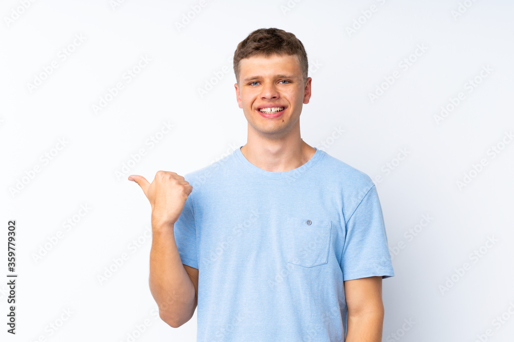 Young handsome man over isolated white background pointing to the side to present a product Young handsome man over isolated white background pointing to the side to present a product