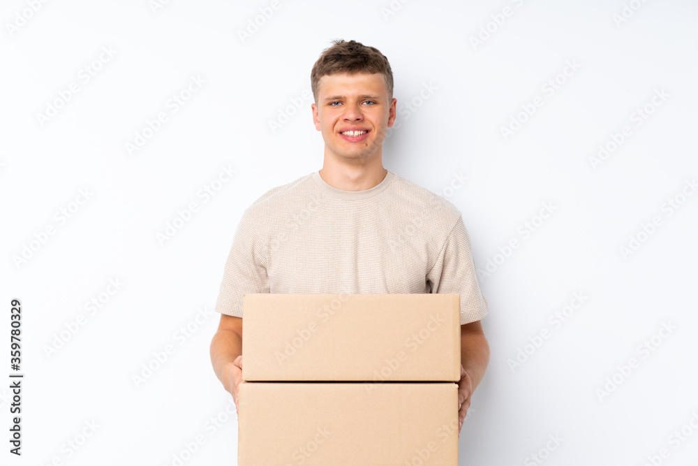 Young handsome man over isolated white background holding a box to move it to another site Young handsome man over isolated white background holding a box to move it to another site