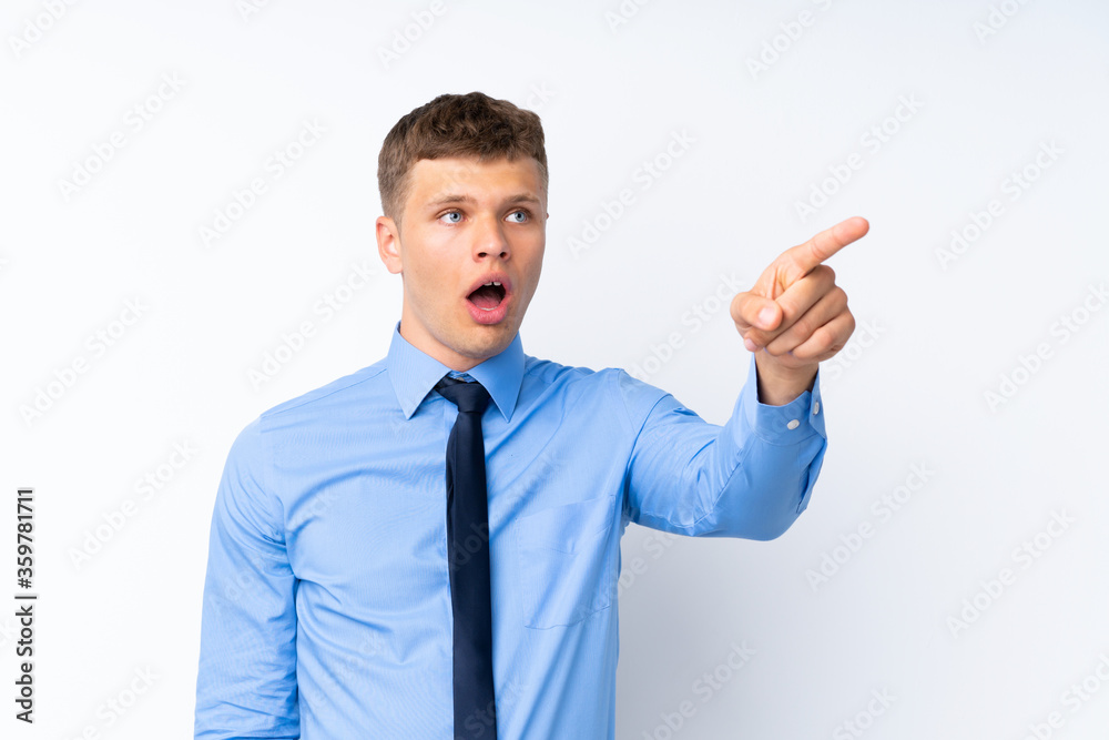 Young handsome businessman pointing away Young handsome businessman pointing away