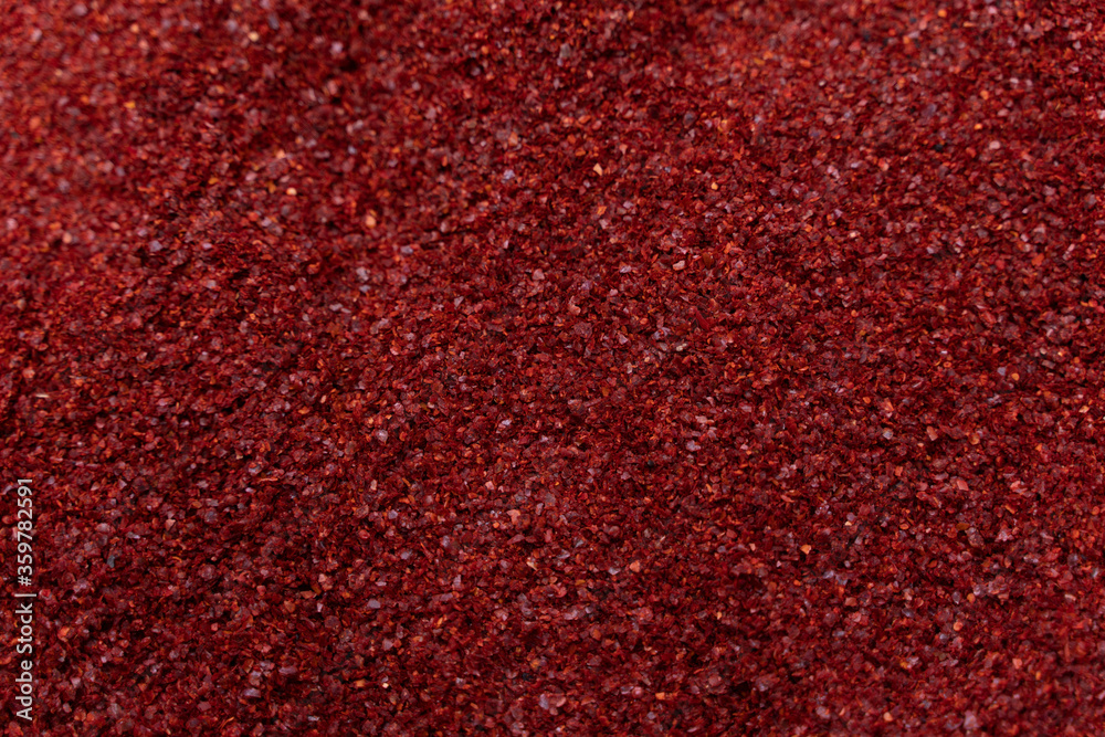 Background of hot dried chili pepper, or crushed red pepper, abstract textureilly pepper flakes closeup or close up photography in the kitchen..