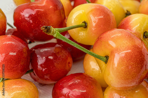 Cherry on a white background. Red and yellow berry closeup macro. Blurred background. Organic fruit. Fresh fruit.