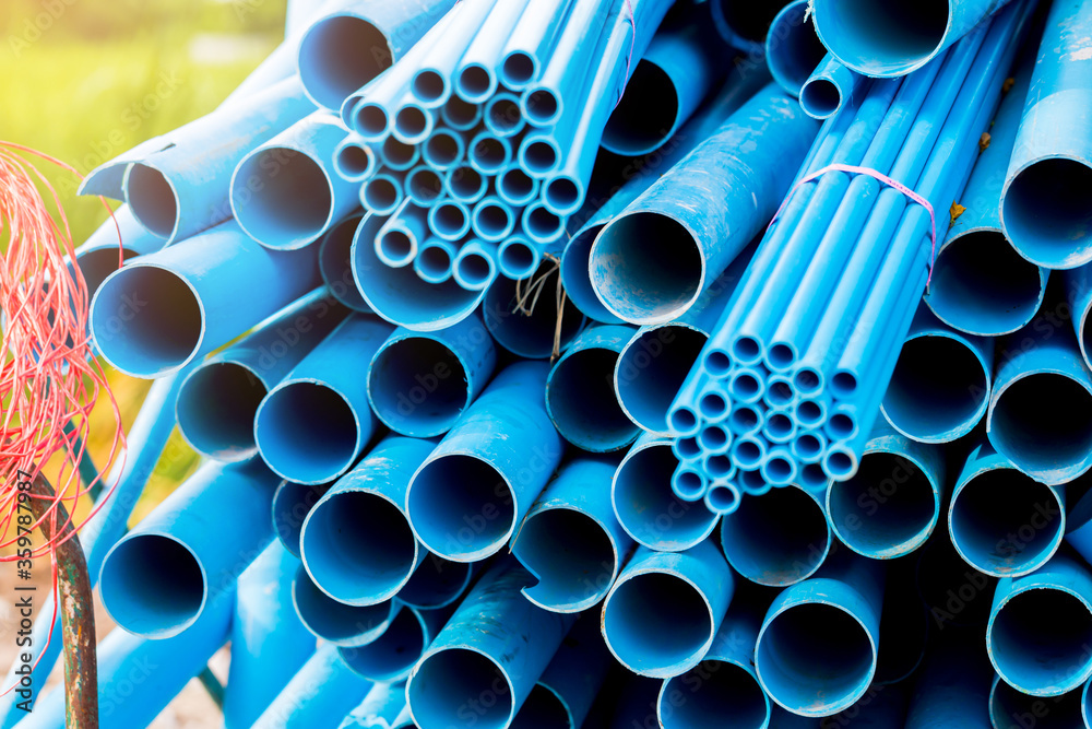 Selective to blue plastic pipe background. PVC pipes stacked in