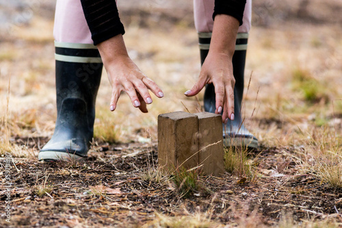 Woman arranging pieces in a game of kubb photo