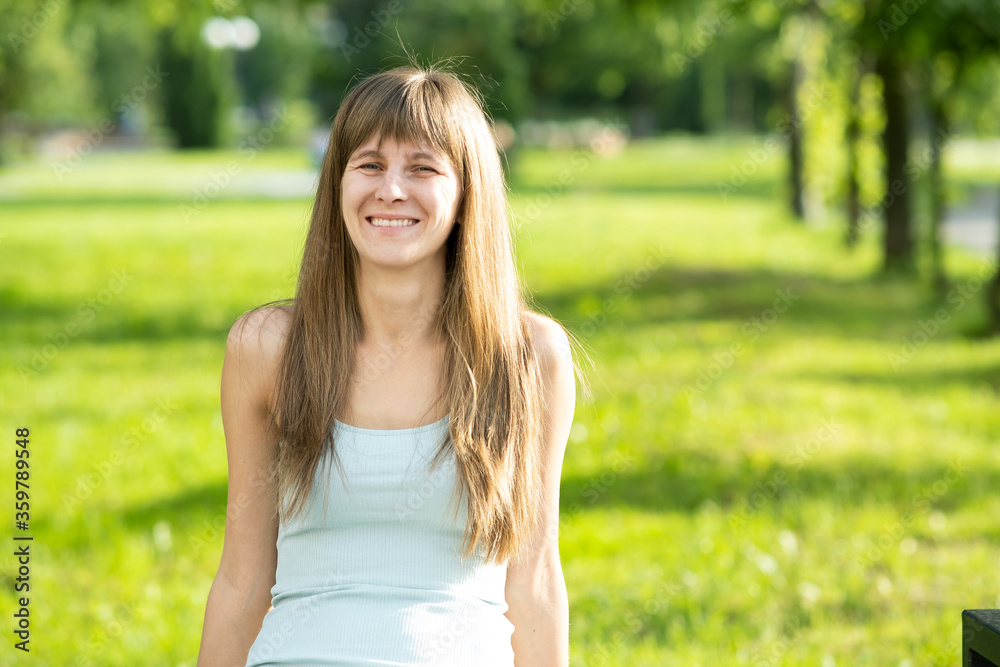 Portrait of pretty young woman in summer park. Portrait of pretty young woman in summer park.