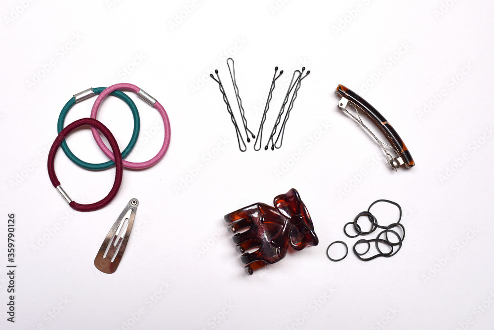 hair tools and accessories- hair bands, bobby pins, hair clips and rubber  bands scattered on a white background Stock Photo | Adobe Stock