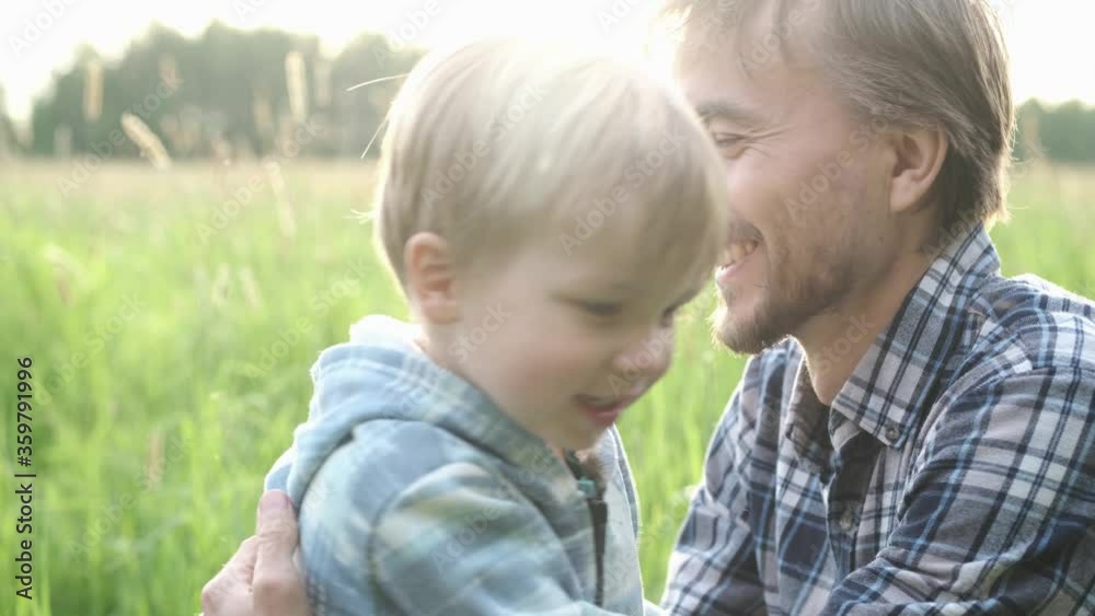 Cute toddler child boy hugging and kissing his father outdoor. Tenderness, love, dad and son relationship, fathers day concept. Happy family moments. Cute toddler child boy hugging and kissing his father outdoor. Tenderness, love, dad and son relationship, fathers day concept. Happy family moments.