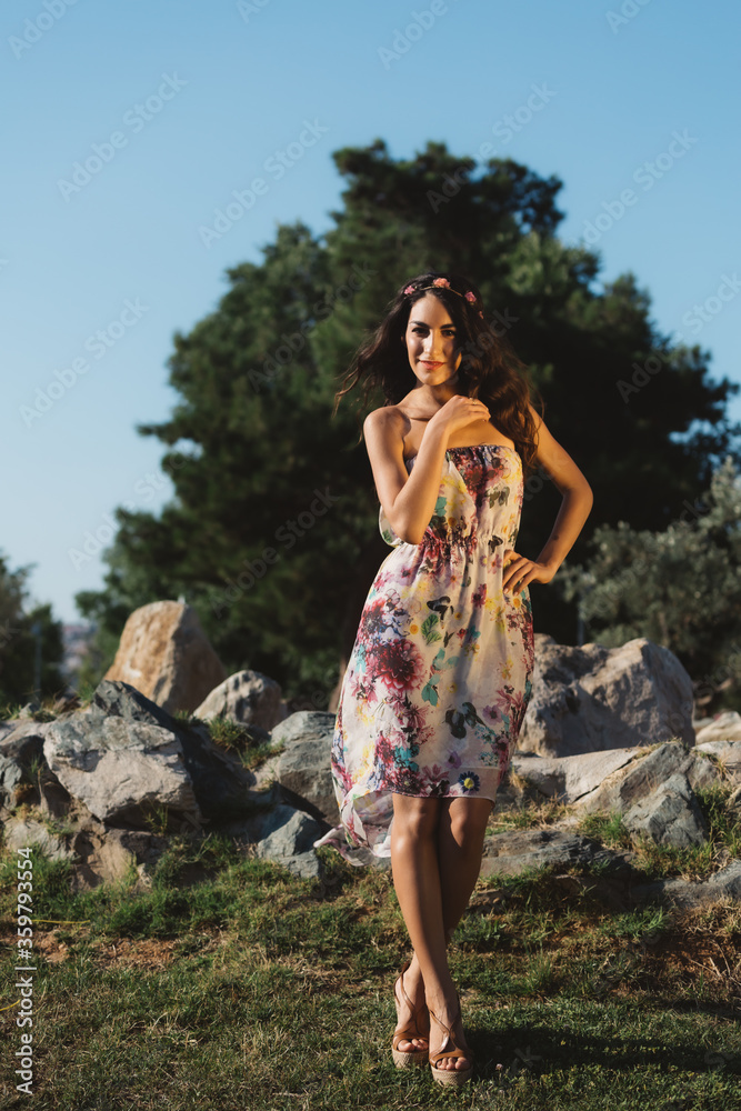 Girl in a dress posing in motion on a street background