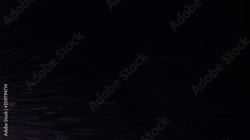 Water spray swirling snow storm falling black background texture effect
