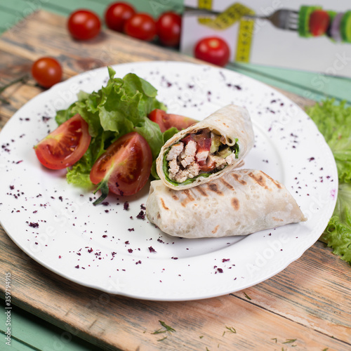 Vegetable salad roll in lavash bread in white plate