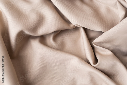 abstract background luxury cloth or liquid wave or wavy folds of grunge silk texture satin velvet material or luxurious Christmas background or elegant wallpaper design, beige background