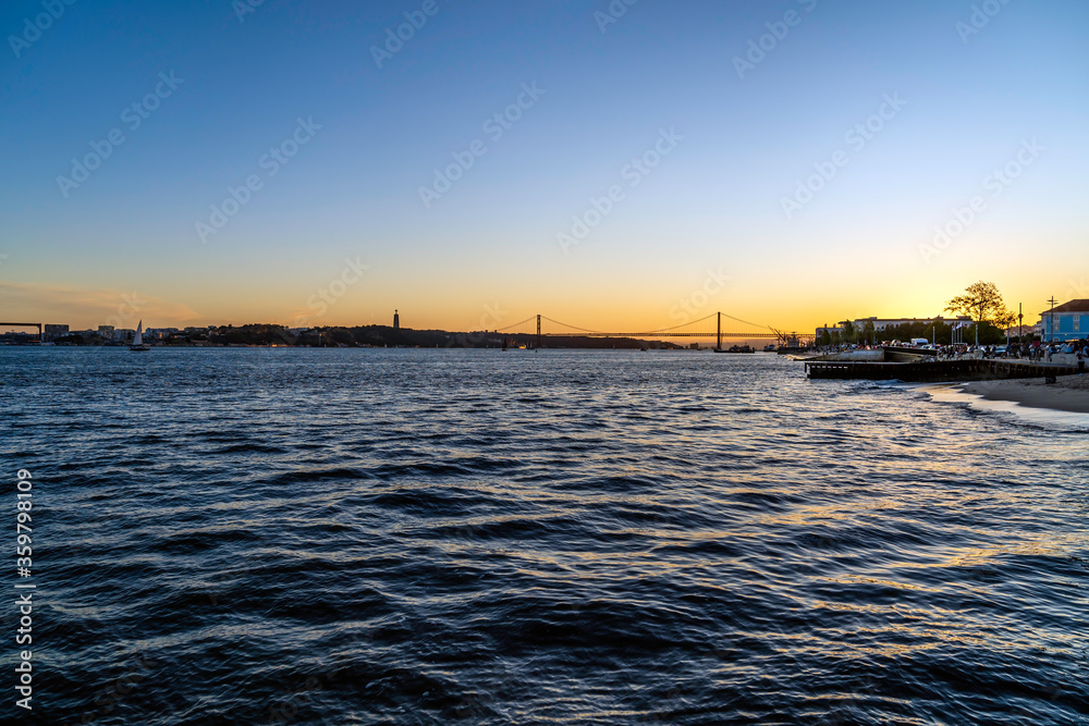 Small beach at sunset by the Tagus river in the city center of Lisbon in Portugal
