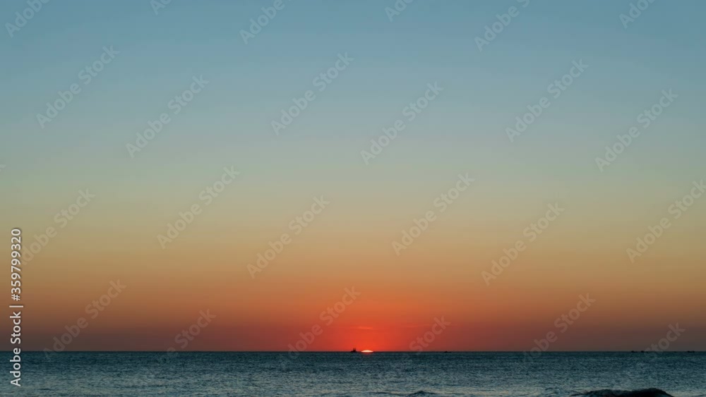 Time lapse: Sunset reflected on wet beach sand with incoming ocean waves. A beached foreground log adds interest. Seamless loop. Shot at 2160p. 4K. Time lapse: Sunset reflected on wet beach sand with incoming ocean waves. A beached foreground log adds interest. Seamless loop. Shot at 2160p. 4K.