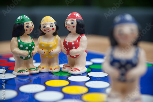 A scene with four figurines showing three female friends talking or whispering confidentially, while another woman looks on. © Christina Felschen