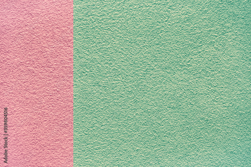 Fototapeta premium Green and pink colors concrete cement stone wall textured background for design and decoration. Two tone abstract background fashionable glamorous divided into two parts.