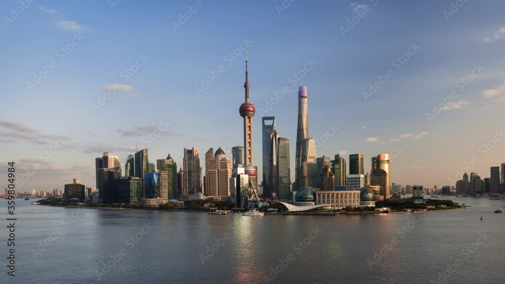 TL/ Asia, China, Shanghai, Time lapse of the Shanghai skyline and Pudong river, busy with cargo ships transporting goods TL/ Asia, China, Shanghai, Time lapse of the Shanghai skyline and Pudong river, busy with cargo ships transporting goods